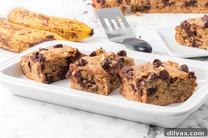 Delicious Banana Blondies fresh out of the oven, topped with chocolate chips and walnuts.