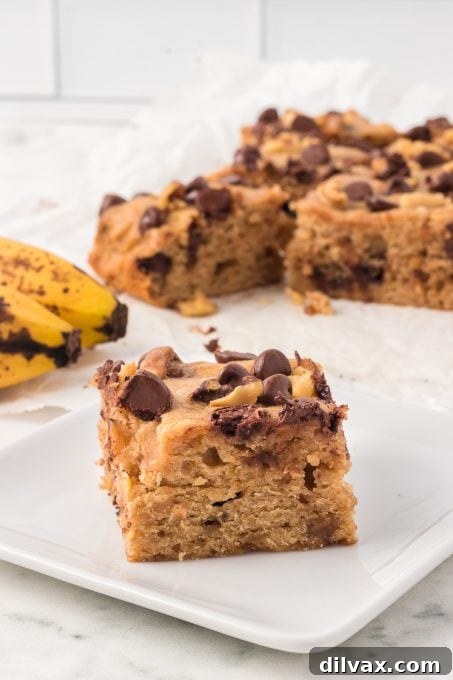 A delicious banana blondie bar with visible chocolate chips and banana pieces.