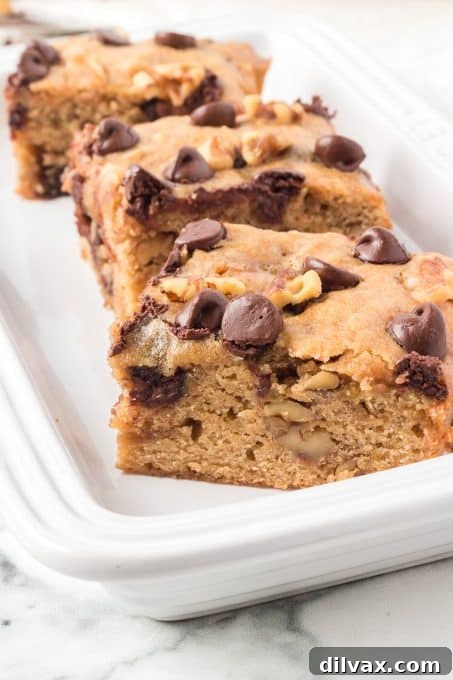 Assortment of Banana Blondies, some with walnuts and some without, arranged artfully.