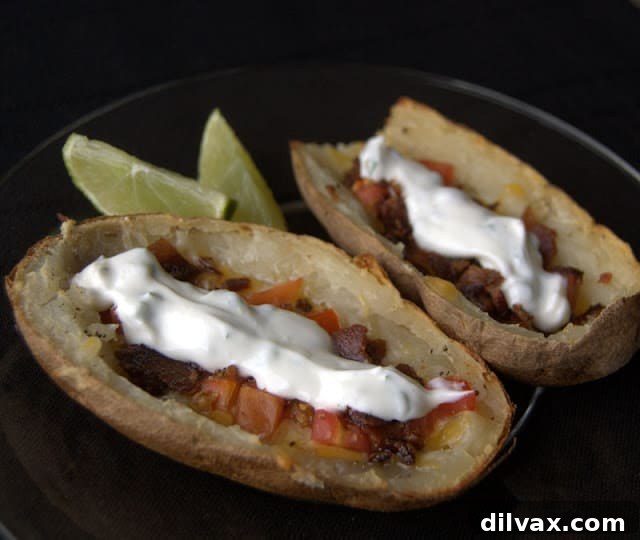 Zesty Lime Sour Cream Potato Skins 5 Close-up of baked potato skins with melted cheese and toppings.