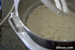 Cupcake batter being mixed in a bowl, showing the consistency as dry ingredients are incorporated with milk