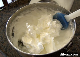 Beaten egg whites with sugar, showing soft peaks, ready to be folded into batter