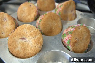 Freshly baked cupcakes cooling completely on a metal wire rack