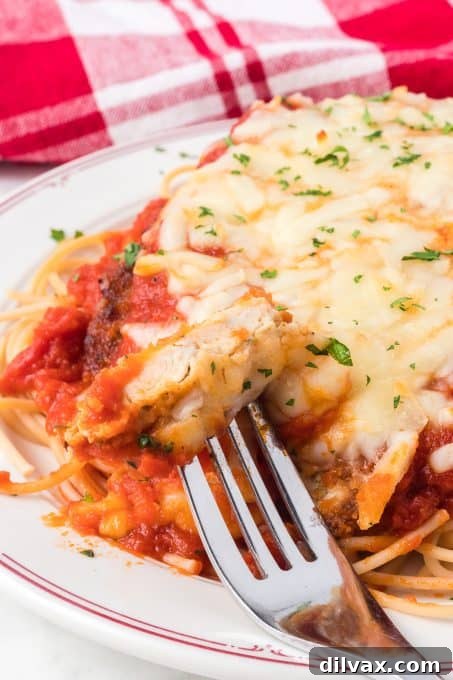 Deliciously Simple Chicken Parmesan 9 A bite of Parmesan chicken.