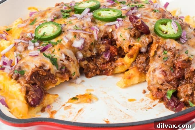 Classic Chili Cheese Fries topped with fresh cilantro and jalapeños.