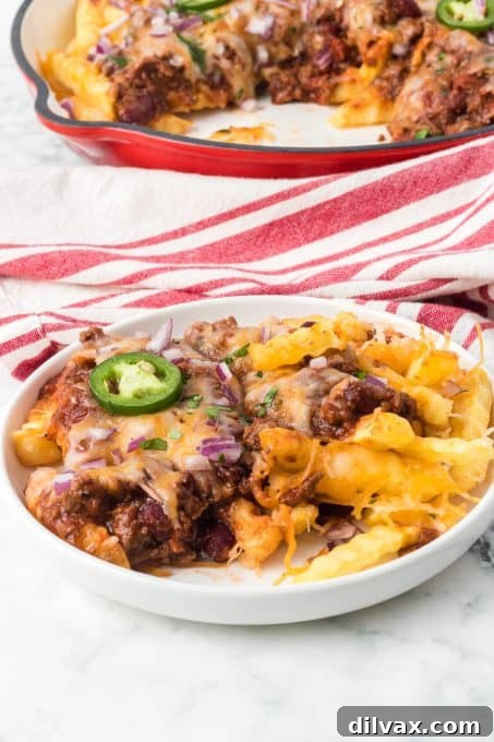 Homemade chili generously spooned over a bed of cheesy French fries.
