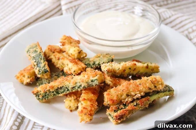 Parmesan Crusted Baked Zucchini Fries 2 Crispy Parmesan Zucchini Fries fresh from the oven, ready to be served.
