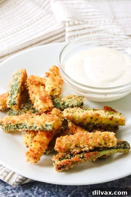 Crispy golden Parmesan breaded zucchini fries fresh from the oven