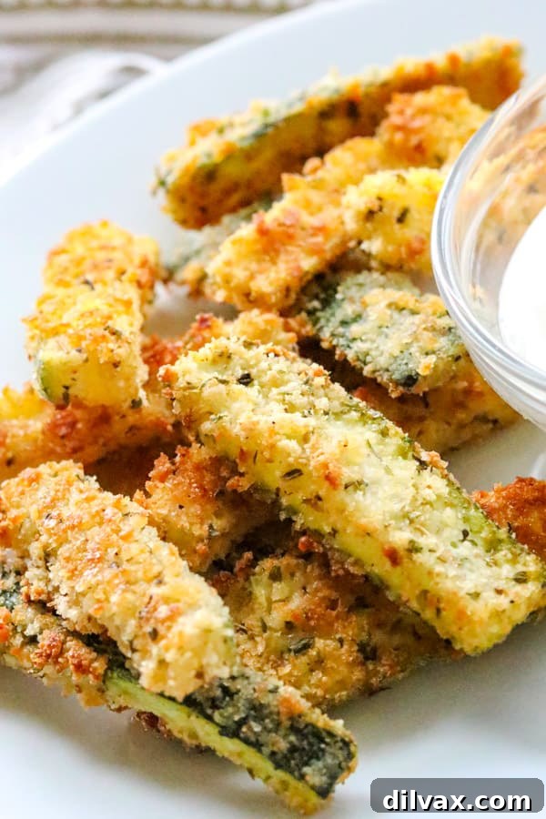 Parmesan Crusted Baked Zucchini Fries 10 Baked Parmesan Zucchini Sticks on a wire rack.