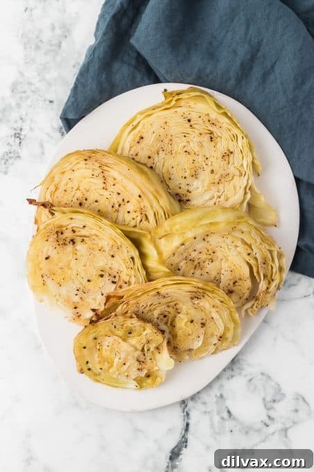 Crispy Roasted Cabbage Steaks 6 A single roasted cabbage steak served on a white plate, garnished with fresh herbs.