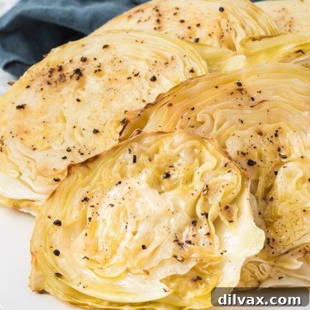 Sliced green cabbage on a plate that has been roasted.
