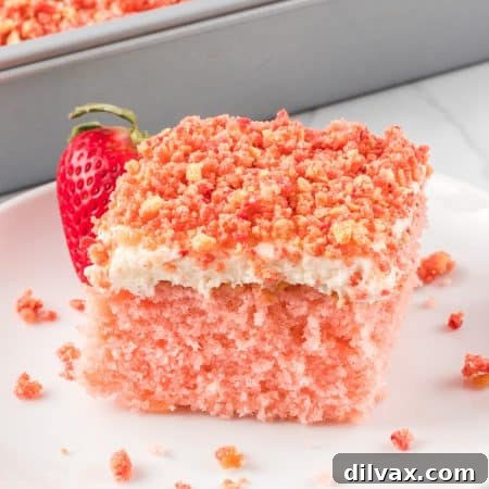 Divine Strawberry Crunch Cake 15 A slice of pink cake on a plate.