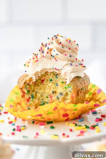 A bite taken out of a Birthday Funfetti Cupcakes