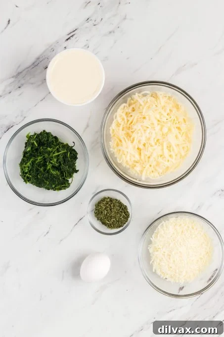 Cheese and spinach stuffed pasta shell ingredients in bowls.