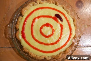 Patriotic Vanilla Berry Pie 6 Strawberry purée being applied in a circle on the pie