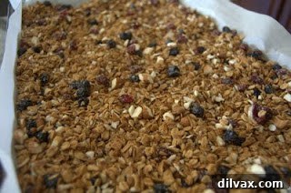 Ingredients for making homemade granola laid out on a surface.
