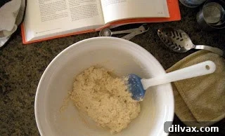Freshly prepared biscuit dough before shaping. Unbaked biscuit dough, lightly patted into a circle on parchment paper, awaiting further steps.
