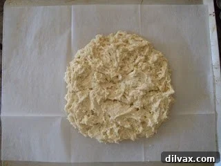 A humorous 'face' in the biscuit dough. Close-up of biscuit dough, with a humorous suggestion of a human-like face visible in its texture and contours.