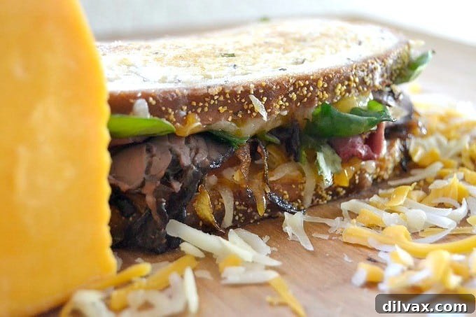 Layers of Wisconsin cheddar and gouda cheeses, caramelized onions, plum chutney and roast beef make up this incredible grilled cheese sandwich!