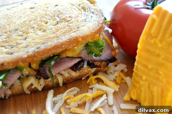 Layers of Wisconsin cheddar and gouda cheeses, caramelized onions, plum chutney and roast beef make up this incredible grilled cheese sandwich!