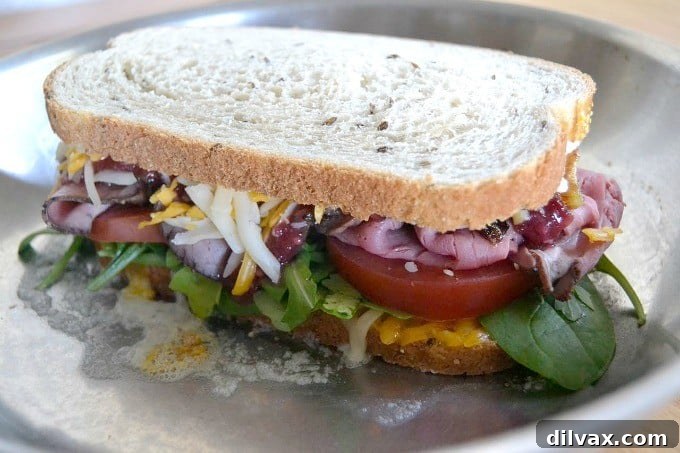 Layers of Wisconsin cheddar and gouda cheeses, caramelized onions, plum chutney and roast beef make up this incredible grilled cheese sandwich!