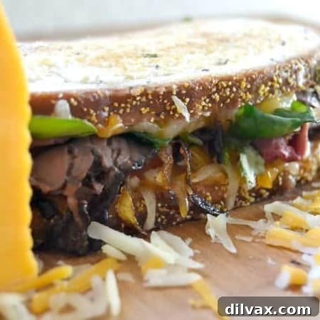 Layers of Wisconsin cheddar and gouda cheeses, caramelized onions, plum chutney and roast beef make up this incredible grilled cheese sandwich!