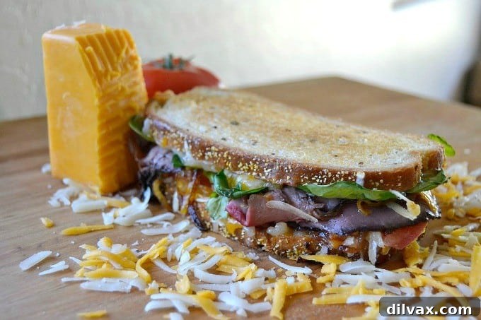 Layers of Wisconsin cheddar and gouda cheeses, caramelized onions, plum chutney and roast beef make up this incredible grilled cheese sandwich!