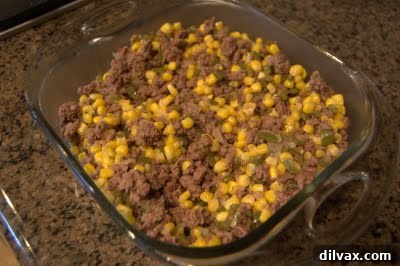 Ground beef, corn, onion, and green pepper mixture in a skillet.