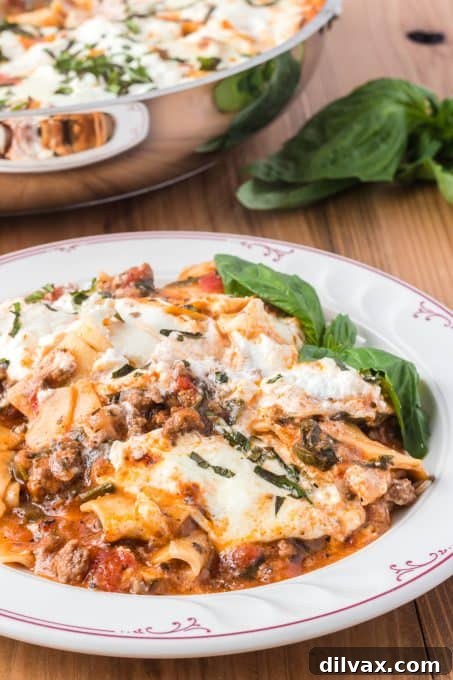 Close-up of Skillet Spinach Lasagna with melted cheese and fresh basil.