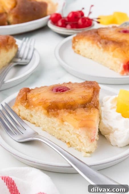 Caramelized Pineapple Flip Cake 10 A beautiful slice of yellow cake with pineapple and cherries, perfect for any occasion.