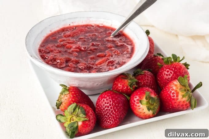 Delicious 3-Ingredient Strawberry Sauce poured over a dessert.