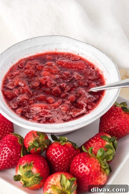 A versatile dessert sauce made with strawberries, sugar, and water, in a rustic setting.