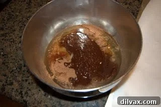 Mixing chocolate, coconut, sugar, egg whites, vanilla, and salt by hand for chocolate macaroons.