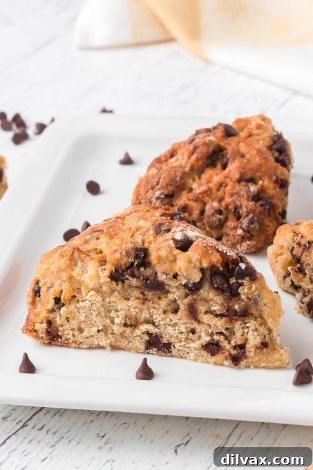 Banana Chocolate Scone Delight 7 An enticing close-up of a single Banana Chocolate Scone, showcasing its perfectly baked exterior, tender crumb, and generous distribution of chocolate chips.
