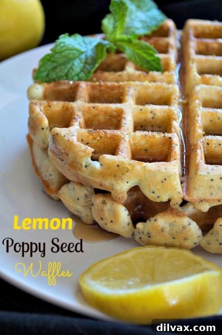 A vertically oriented image showcasing Dairy-Free Lemon Poppy Seed Waffles, topped with powdered sugar and fresh lemon slices. The focus is on the delicious texture and inviting presentation, ideal for pinning on Pinterest.