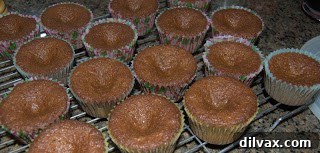 Spiced Butterscotch Cupcakes with Cream Cheese Frosting 3 Freshly baked cupcakes cooling on a wire rack