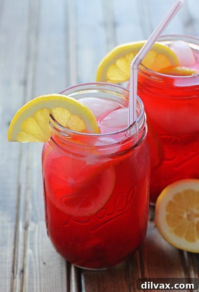 Pink Lemonade for Two, served in two elegant glasses with lemon slices, perfect for a small gathering.
