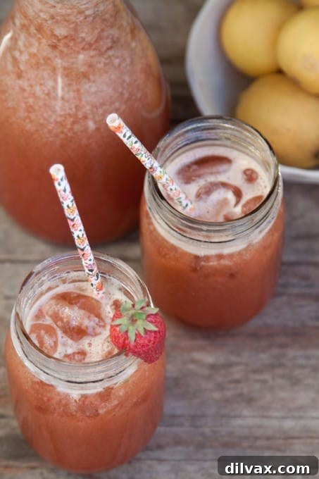 Strawberry Basil Lemonade, a red drink with fresh strawberries, basil, and lemon, a popular summer combination.