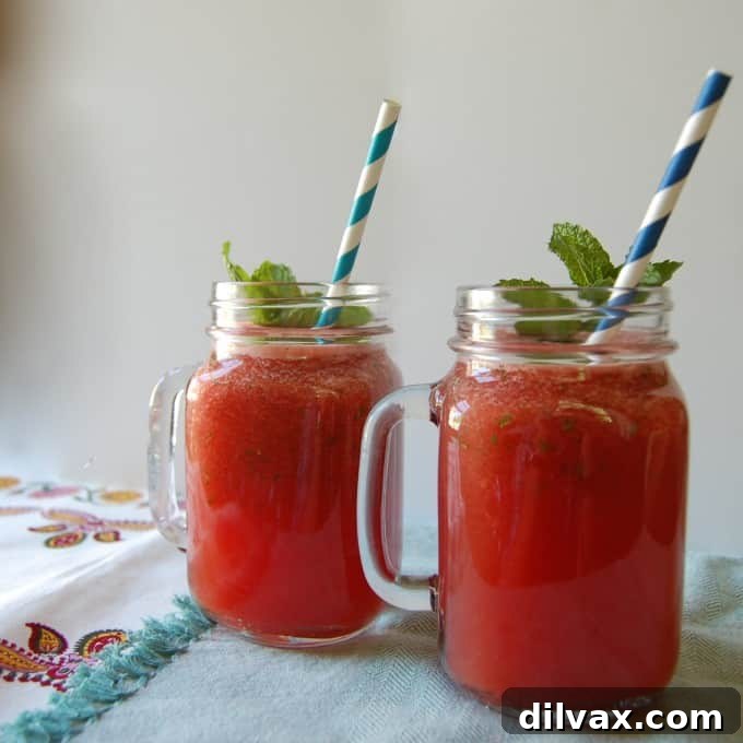 Watermelon Lemonade Vodka Slushy, a pink icy cocktail with watermelon and lemon, perfect for adults.