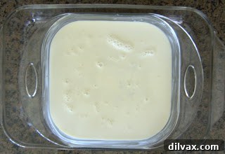 Day 124: Indian Pudding Delight 4 Pouring cold milk over Indian Pudding mixture in baking dish