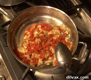 Savory Stuffed Zucchini 3 Sautéing chopped zucchini pulp and tomatoes in a skillet for the filling.