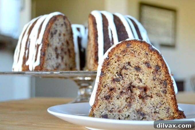 Decadent Double Chocolate Banana Loaf 10 A moist and delicious banana bundt cake filled with mini chocolate chips, elegantly drizzled with a creamy cream cheese frosting.