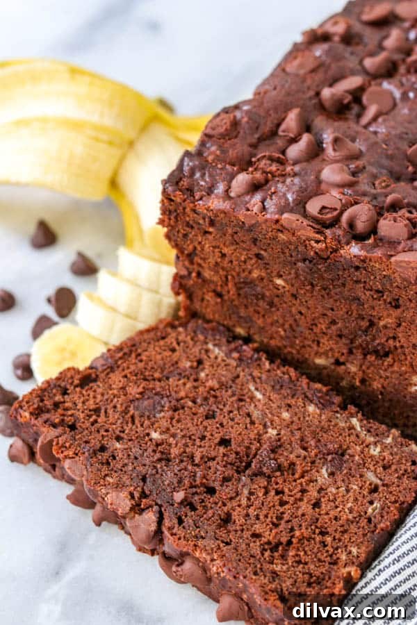 Decadent Double Chocolate Banana Loaf 4 Close-up of a rustic-looking Double Chocolate Banana Bread loaf, showcasing its cracked top and delicious texture.