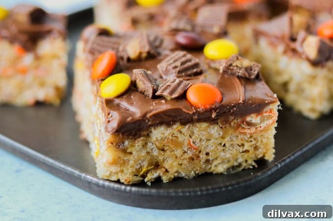 Reese's Peanut Butter Krispie Crunch 2 Delicious Reese's Peanut Butter Rice Krispies Treats with a generous layer of chocolate frosting and chopped Reese's cups.