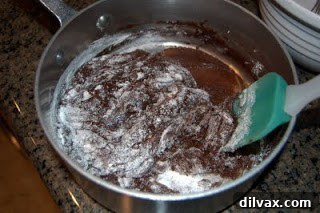 Grown-Up Brownies 3 Mixing brownie batter with Bailey's Irish Cream, sugar, egg, salt, and flour.