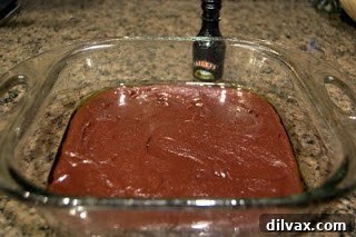 Grown-Up Brownies 4 Spreading thick brownie batter evenly into a square baking dish.