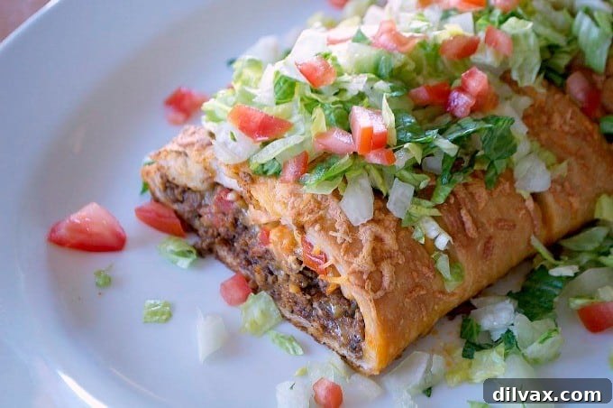 Taco Braid hero shot, golden and perfectly baked, with fresh toppings and a side of sour cream and taco sauce.