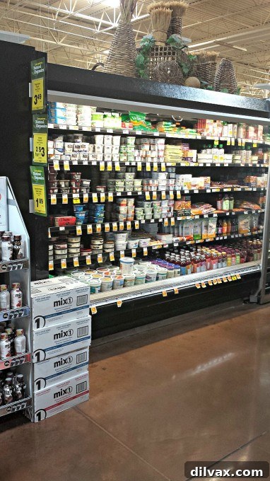 A refrigerated aisle display featuring a variety of Silk Dairy-Free Yogurt alternatives in a grocery store, ready for selection.