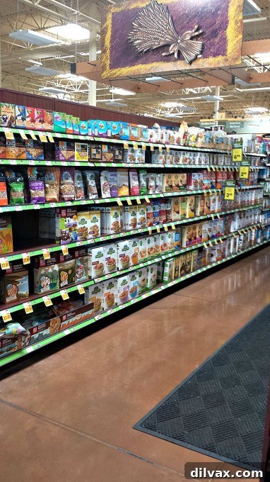 An aisle in a grocery store showcasing a wide variety of cereals and granolas, including Simple Truth products, perfect for a breakfast bar.