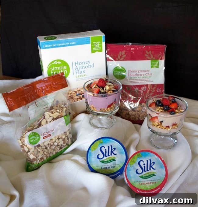 Hands layering ingredients into a glass for a breakfast parfait, showing the interactive nature of a parfait bar with various toppings.